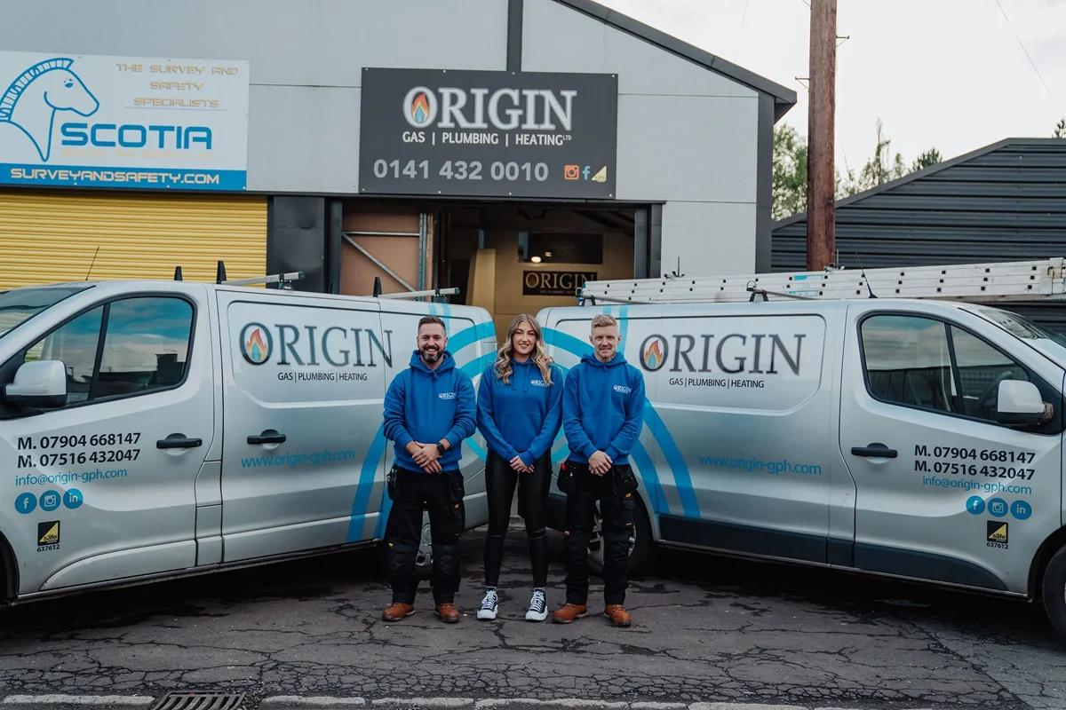 Professional plumber from Origin Gas, Plumbing and Heating Ltd. performing emergency repairs on a boiler in Glasgow.